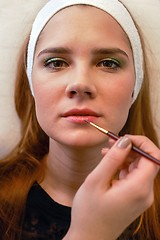 Image showing Young woman getting beautiful makeup