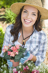 Image showing Young Adult Woman Wearing Hat Gardening Outdoors