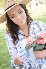 Image showing Young Adult Woman Wearing Hat Gardening Outdoors