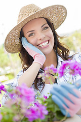 Image showing Young Adult Woman Wearing Hat Gardening Outdoors