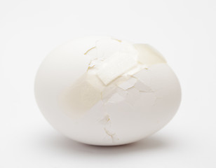 Image showing Cracked white egg with plastic plaster