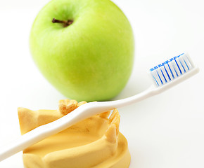 Image showing Dental health care concept, green apple and toothbrush