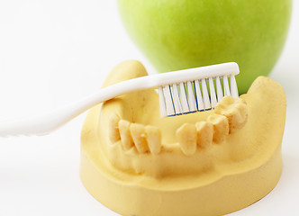 Image showing Dental health care concept, green apple and toothbrush