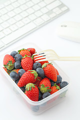 Image showing Berry mix lunch on working desk in office