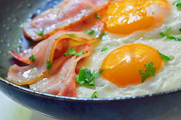 Image showing fried egg with bacon in a frying pan