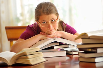 Image showing Teen girl learning at the desk, looking up