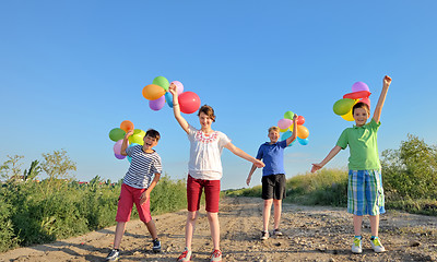 Image showing happy children with colorful balloons 