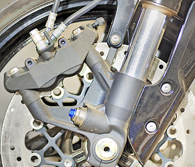 Image showing Closeup detail of a motorcycle's front wheel 