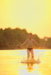 Image showing boy jumping in river