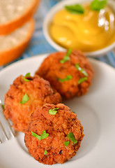 Image showing meat balls with mustard on white dish