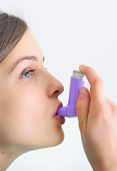 Image showing girl using an inhaler for Asthma