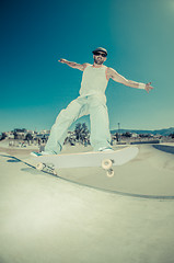 Image showing Skateboarder in a concrete pool 