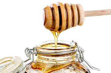 Image showing Jar of honey with wooden drizzler