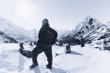 Image showing Mountain climbing: Alpinist on the peak in the Himalaya 