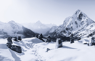 Image showing Cho La pass and stone stacks at sunrise in Himalaya