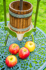 Image showing apples with old fruit press