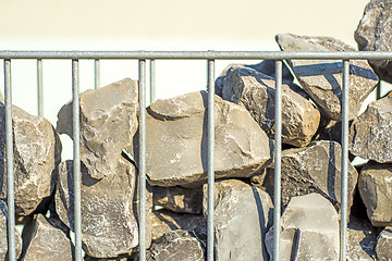 Image showing steel fence with stones