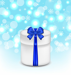 Image showing gift box with blue bow on glowing background