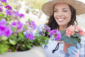 Image showing Young Adult Woman Wearing Hat Gardening Outdoors