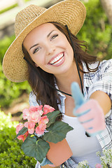 Image showing Young Adult Woman Wearing Hat Gardening Outdoors