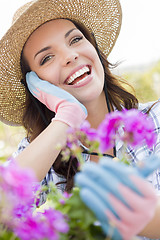 Image showing Young Adult Woman Wearing Hat Gardening Outdoors