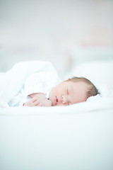 Image showing Newborn Baby Laying on White Bed