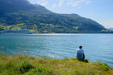 Image showing A man watching a cruise ship