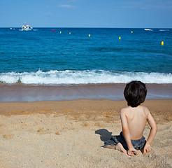 Image showing child sitting on the shore