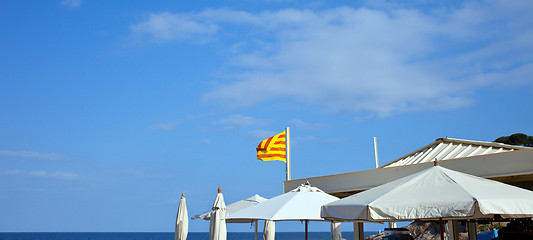 Image showing White umbrellas and the flag of Catalunya