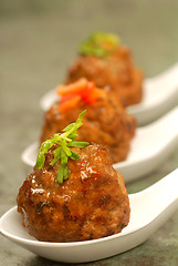 Image showing Asian styled meatballs on spoons with a variety of toppings