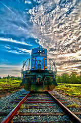 Image showing blue freight train engine at sunrise 