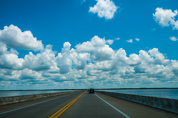 Image showing driving on road with water on both sides