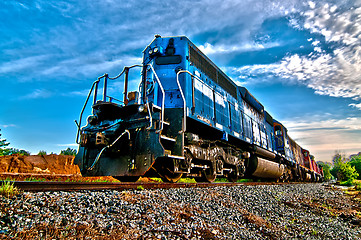 Image showing blue freight train engine at sunrise 