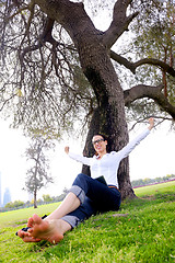 Image showing Beautiful young woman with  tablet in park