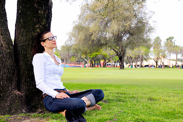 Image showing Beautiful young woman with  tablet in park