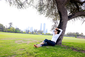 Image showing Beautiful young woman with  tablet in park