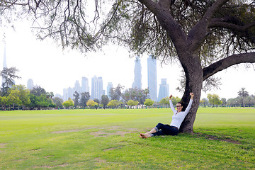 Image showing Beautiful young woman with  tablet in park