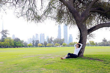 Image showing Beautiful young woman with  tablet in park