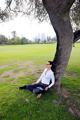 Image showing Beautiful young woman with  tablet in park