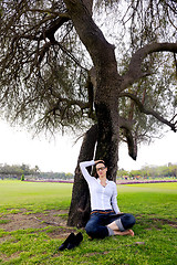 Image showing Beautiful young woman with  tablet in park