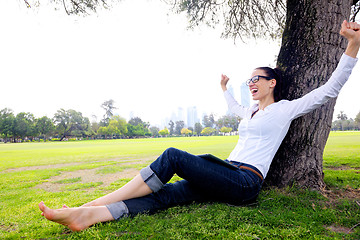 Image showing Beautiful young woman with  tablet in park