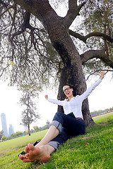 Image showing Beautiful young woman with  tablet in park