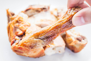 Image showing Close up grilled chicken leg on hand 