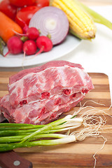 Image showing chopping fresh pork ribs and vegetables