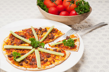 Image showing Turkish beef pizza with cucumber on top