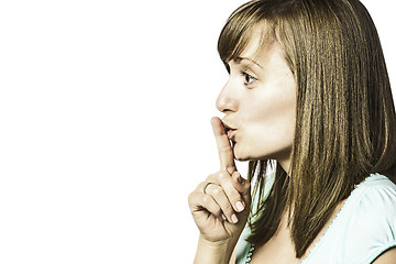 Image showing Young girl holds a finger to his mouth
