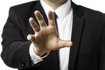 Image showing Businessman in a suit holds out his hand