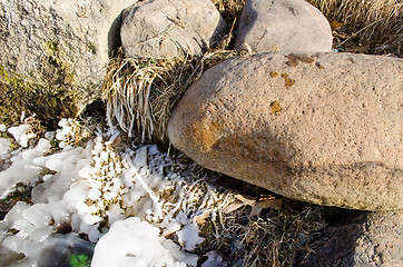 Image showing large stones lit icy grass 