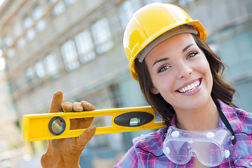 Image showing Young Attractive Female Construction Worker Wearing Hard Hat and
