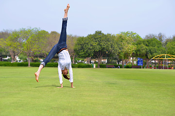 Image showing young woman jumping in park